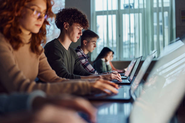 Students working together on laptops in a classroom